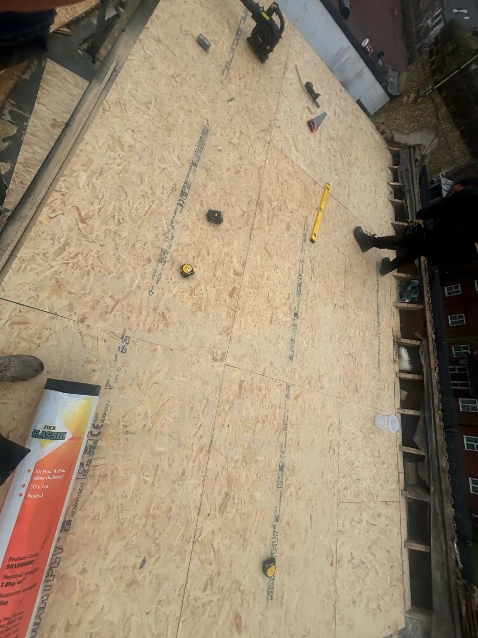 Standing water and a split seam on an ageing flat roof