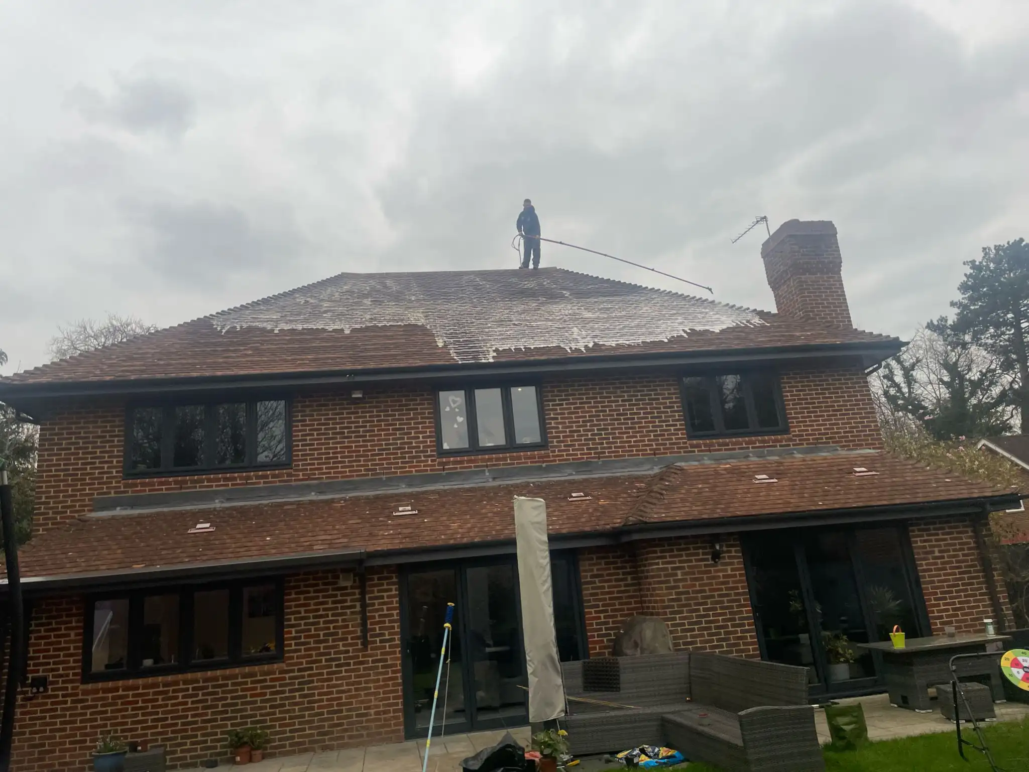 Moss being removed by hand on a roof in Beaconsfield